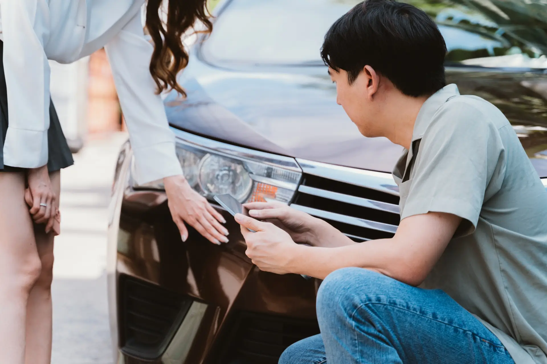 people inspecting the damage of a car accident