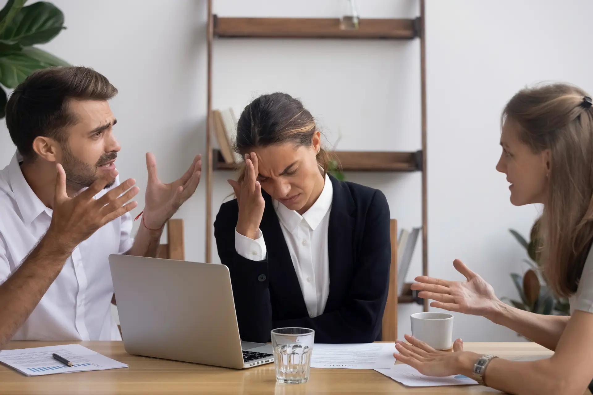 People arguing while a lawyer is holding their head listening